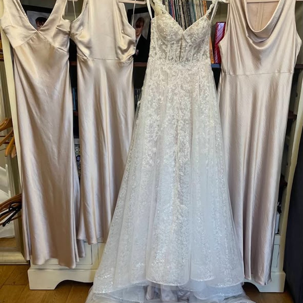 A sparkling ivory wedding gown with champagne satin bridesmaid dresses